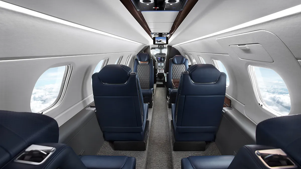 Interior da cabine do Embraer Phenom 300EV com assentos em couro