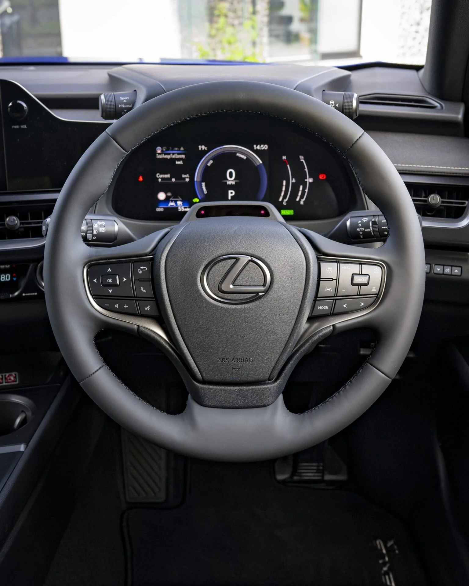 Volante do Lexus UX 300h e quadro de instrumentos digital com indicador de fluxo do sistema híbrido.