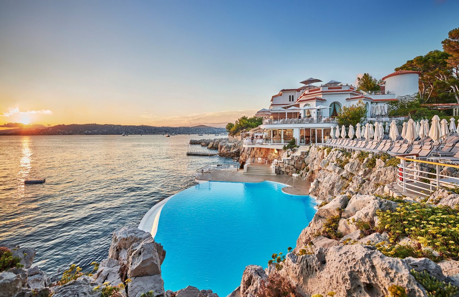 A piscina do Eden-Roc sobre as rochas de Cap d'Antibes ao pôr do sol